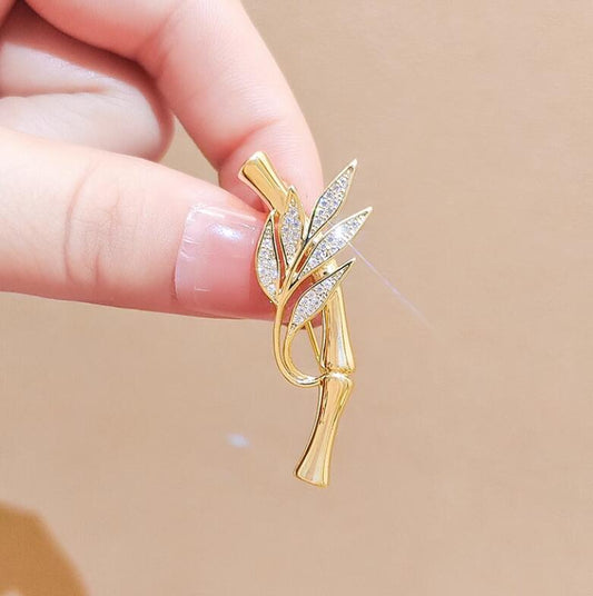 Gold bamboo brooch with crystal-studded leaves