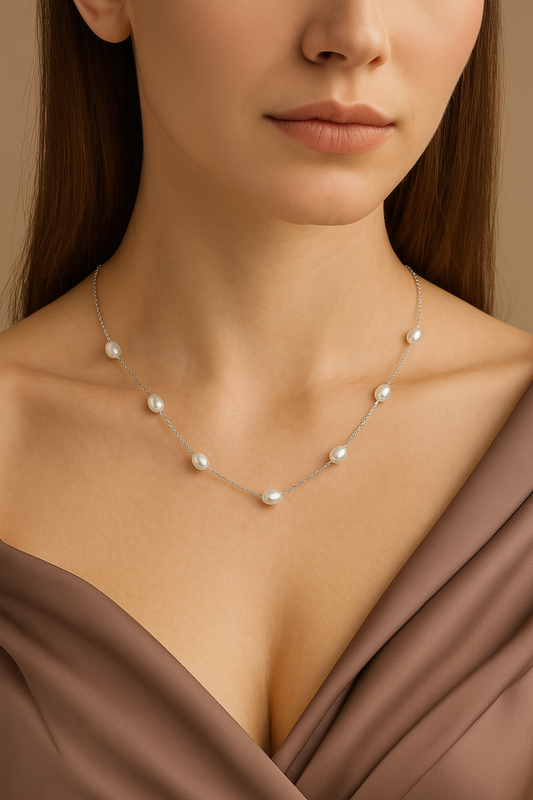 Woman wearing minimalist freshwater pearl necklace by Zewaraat, styled with western gown.