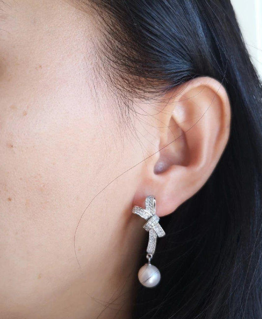 Handcrafted silver drop earrings with pearl charm