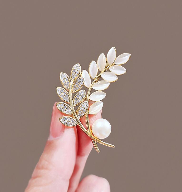Elegant leaf brooch pin with gold, pearl, and rhinestones

