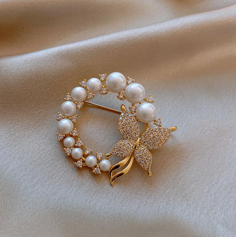 Elegant pearl circle butterfly brooch in gold finish