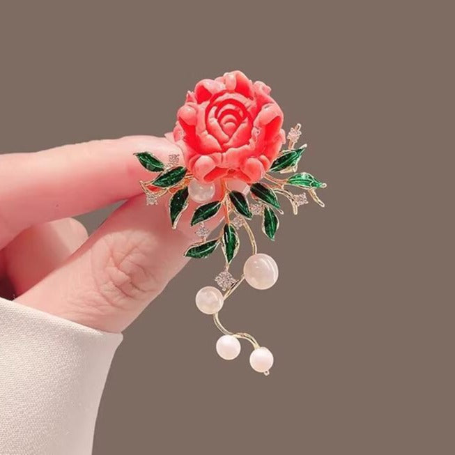 Floral brooch with dangling pearls and sculpted details