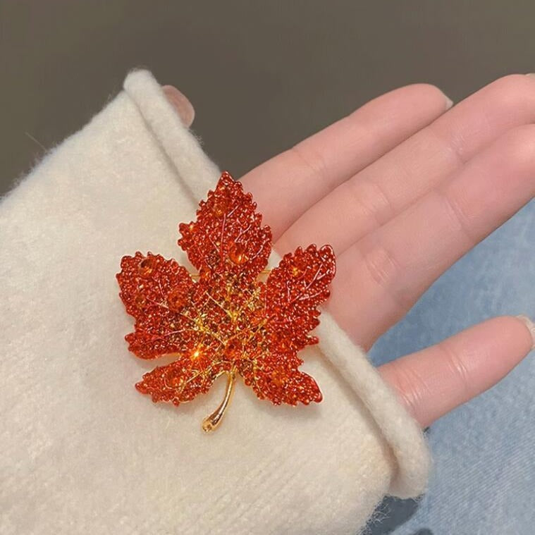 Gold plated maple leaf pin with sparkling rhinestones

