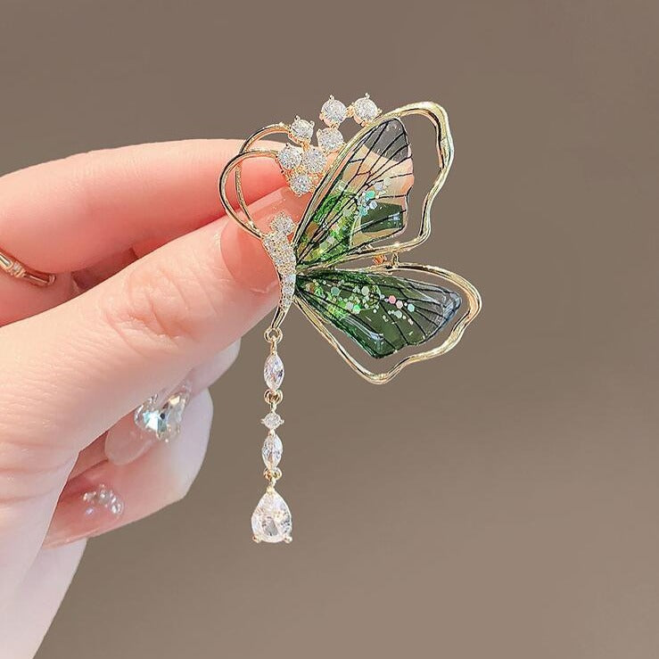 Green butterfly brooch with dangling teardrop crystal

