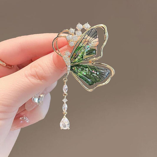 Green butterfly brooch with dangling teardrop crystal

