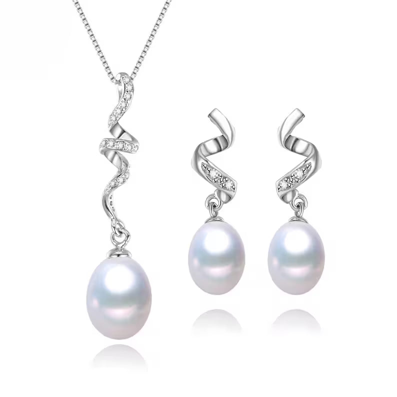 Close-up of twisted sterling silver pendant with freshwater pearl and cubic zirconia accents

