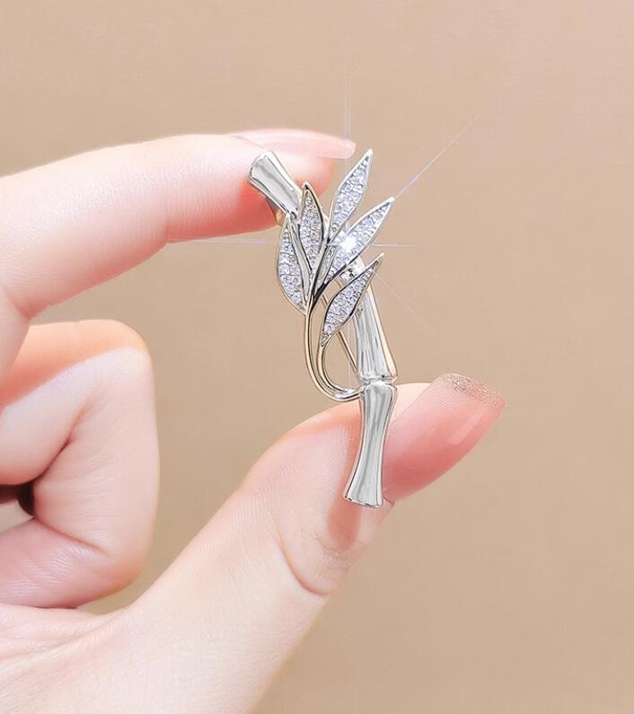 Silver bamboo leaf brooch with crystal accents