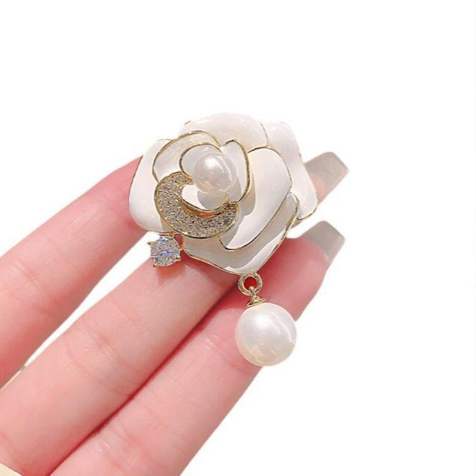 White flower brooch with rhinestones and pearl accent