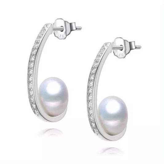 Minimalist sterling silver earrings with round freshwater pearl accent, modern curved design