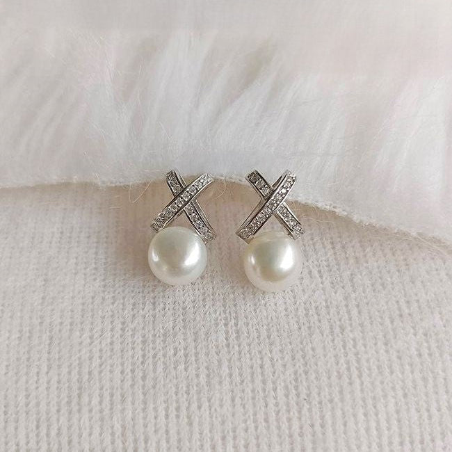 Pink-lavender pearl earrings with silver crisscross top