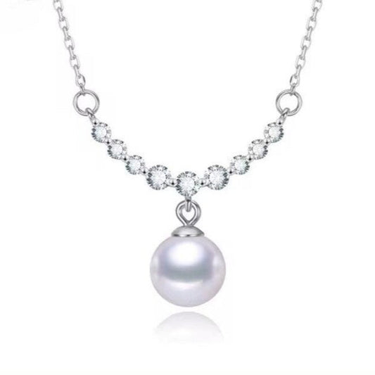 925 sterling silver necklace featuring a round freshwater pearl pendant and round-cut zircon stones in a graceful arc setting